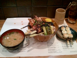 Miso soup, yakitori don (with a few pickle slices in the bowl) and quail egg yakitori, bamboo pot for sticks at the back