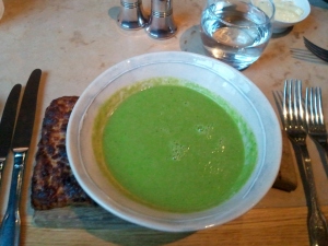 A radioactive green pea soup with Welsh rarebit on the left
